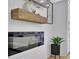 Interior decor with a modern fireplace, floating wood shelf, and decorative items at 701 Smith St, Atlanta, GA 30310