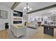 Open concept living room with modern decor, beams, fireplace and stylish furnishings at 701 Smith St, Atlanta, GA 30310