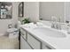 Clean bathroom with a white vanity, modern fixtures, toilet, and decorative artwork on the wall at 106 Holt Ln, Lawrenceville, GA 30046