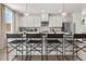 Kitchen with island seating, showcasing white cabinets, stainless steel appliances, and pendant lighting at 106 Holt Ln, Lawrenceville, GA 30046