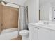 Neutral bathroom with modern white vanity, tile shower, and tub at 120 Generals Pl, Canton, GA 30114