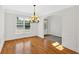 Bright and spacious dining room with hardwood floors, wainscoting, large windows, and an elegant chandelier at 120 Generals Pl, Canton, GA 30114