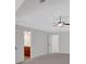 An empty room with doors leading to other rooms and a tray ceiling with fan at 120 Generals Pl, Canton, GA 30114