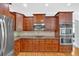 Well-appointed kitchen boasts stainless steel appliances, a double oven, wood cabinetry, and granite countertops at 120 Generals Pl, Canton, GA 30114