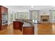 Open kitchen with an island bar, granite countertops, stainless steel appliances, and hardwood floors at 120 Generals Pl, Canton, GA 30114
