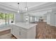 Kitchen island views open layout living area with fireplace, built-ins, and backyard access at 120 Generals Pl, Canton, GA 30114