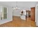 Open living space showing hardwood floors, kitchen with island, and natural light from windows at 120 Generals Pl, Canton, GA 30114