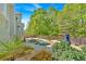 Backyard with a large in-ground pool, hot tub, and privacy fence surrounded by mature trees and lush landscaping at 120 Generals Pl, Canton, GA 30114