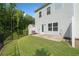 The backyard shows a lush green lawn, black metal fence, and a small concrete patio with access to the home at 235 Centennial Cir, Canton, GA 30114