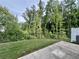 A well-maintained backyard features a metal fence, grassy area and an air conditioning unit on the side at 235 Centennial Cir, Canton, GA 30114