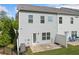Backyard featuring gray vinyl siding, a patio, and lush trees enhancing privacy at 235 Centennial Cir, Canton, GA 30114