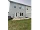Backyard features a concrete patio, grassy area and gray siding on the home's exterior at 235 Centennial Cir, Canton, GA 30114