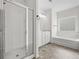 Bathroom with glass shower enclosure, soaking tub, and tiled floors at 235 Centennial Cir, Canton, GA 30114