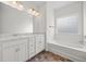 Bathroom showcasing double vanity, soaking tub, and decorative window at 235 Centennial Cir, Canton, GA 30114