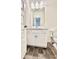 Bathroom featuring a stylish vanity with marble countertop, updated fixtures and neutral color palette at 235 Centennial Cir, Canton, GA 30114