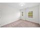 Bright bedroom with two windows bringing in natural light and neutral colored carpet at 235 Centennial Cir, Canton, GA 30114
