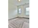 Bright bedroom with two windows allowing ample natural light and neutral walls, plus carpeted floors at 235 Centennial Cir, Canton, GA 30114