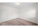 Cozy bedroom featuring neutral carpet, two doors, and white walls for versatile styling at 235 Centennial Cir, Canton, GA 30114