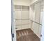 Walk in closet with carpeted floors, and built-in shelving with metal hanging rods at 235 Centennial Cir, Canton, GA 30114