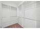 Bright walk-in closet featuring multiple rods and ample shelving for optimal organization at 235 Centennial Cir, Canton, GA 30114