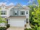 Charming two-story home with gray siding, a two-car garage, and attractive landscaping at 235 Centennial Cir, Canton, GA 30114