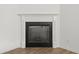 Elegant fireplace with white mantel and black surround, with wood-look floors at 235 Centennial Cir, Canton, GA 30114