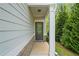 Inviting front entrance of home with modern door, white pillars, and fresh landscaping at 235 Centennial Cir, Canton, GA 30114