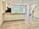Spacious kitchen featuring a breakfast bar, modern pendant lighting, and an adjacent dining area at 235 Centennial Cir, Canton, GA 30114