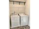Functional laundry room with a washer, dryer, and storage shelf, designed for convenience and organization at 235 Centennial Cir, Canton, GA 30114