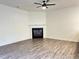 Cozy living room with a modern fireplace, neutral walls, and stylish wood flooring, perfect for relaxing at 235 Centennial Cir, Canton, GA 30114