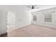 Spacious primary bedroom with neutral carpeting, two windows, and ensuite bathroom entrance at 235 Centennial Cir, Canton, GA 30114