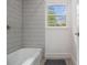 Bathroom featuring tiled shower and a window at 2361 Woodward Nw Way, Atlanta, GA 30305