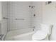 Bathroom featuring a white tiled shower and bath combo with updated fixtures at 2361 Woodward Nw Way, Atlanta, GA 30305