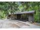 Exterior view of a house with a screened patio, set amidst lush greenery and mature trees at 2361 Woodward Nw Way, Atlanta, GA 30305