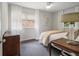 Bright bedroom featuring hardwood floors, a ceiling fan, and a decorative side table at 2361 Woodward Nw Way, Atlanta, GA 30305