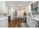 Bright kitchen features white cabinetry, hardwood floors, stainless steel appliances, and large window at 2361 Woodward Nw Way, Atlanta, GA 30305