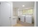 Well-lit laundry room with modern washer and dryer, sink, and ample counter space at 2361 Woodward Nw Way, Atlanta, GA 30305