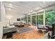 Bright living room featuring large windows, modern furniture, and beautiful hardwood floors at 2361 Woodward Nw Way, Atlanta, GA 30305