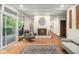 Inviting living room featuring a brick fireplace, exposed ceiling beams, and great natural light at 2361 Woodward Nw Way, Atlanta, GA 30305