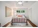 Cozy bedroom with wood floors, a plush rug, and a charming metal bed frame at 2361 Woodward Nw Way, Atlanta, GA 30305