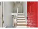 Bright entryway featuring fresh paint, wooden stairs with white rails, and a red door at 3344 Northcrest Rd # A, Atlanta, GA 30340