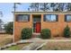 Brick home featuring black shutters, a red front door and a manicured yard at 3344 Northcrest Rd # A, Atlanta, GA 30340