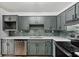 Modern kitchen features stainless steel appliances, gray cabinets and mosaic tile backsplash at 3344 Northcrest Rd # A, Atlanta, GA 30340