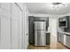 Bright kitchen features stainless steel appliances, grey cabinetry, and modern lighting at 3344 Northcrest Rd # A, Atlanta, GA 30340