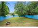Fenced backyard featuring lush green grass and a stone fire pit at 3378 Lavista Dr, Atlanta, GA 30354