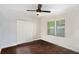 Minimalist bedroom with ceiling fan, large closet, and view from window at 3378 Lavista Dr, Atlanta, GA 30354