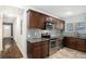 Well-equipped kitchen with stainless steel appliances, granite counters, and dark wood cabinets at 3378 Lavista Dr, Atlanta, GA 30354