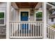 Inviting porch with blue door, white railings and decorative star on updated bungalow at 3378 Lavista Dr, Atlanta, GA 30354