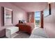 Cozy bedroom with painted pink walls, wood-look floors, and a large window for ample light at 375 Ralph Mcgill Blvd # 1503, Atlanta, GA 30312