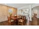 Dining area features a wood table and opens to the kitchen with a white island and stainless steel appliances at 1299 W Wesley Nw Rd, Atlanta, GA 30327